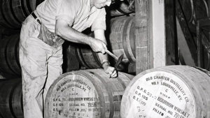 Distiller Joseph Wathen plugs a bourbon whiskey barrel