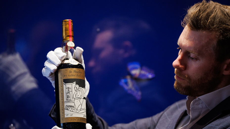 Sotheby's global head of spirits Jonny Fowle presents the $2.7 million bottle of Macallan Valerio Adami 60 year old bottled in 1926.